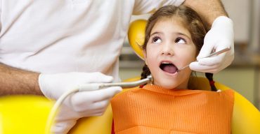 criança no dentista tratando os problemas bucais na infância